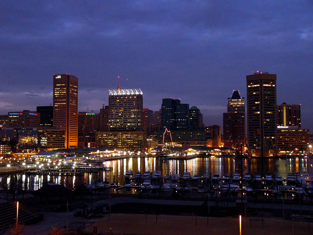 The Baltimore Inner Harbor at dusk, lights reflected on the water